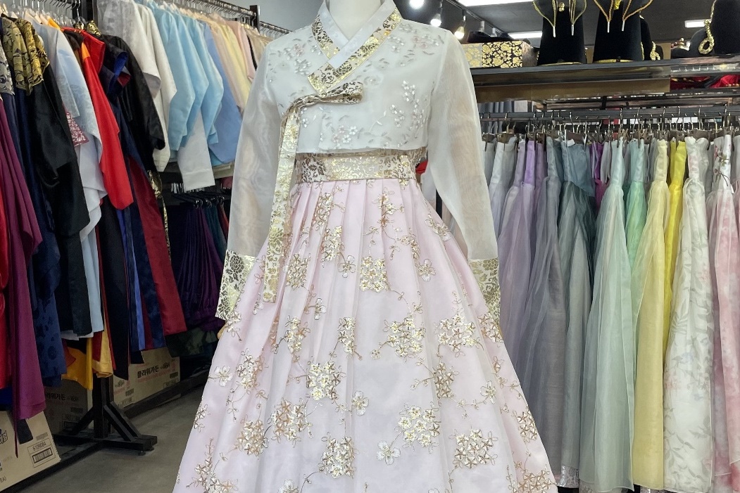 Graceful Hanbok dress with floral embroidery on display at InKorea Hanbok rental.